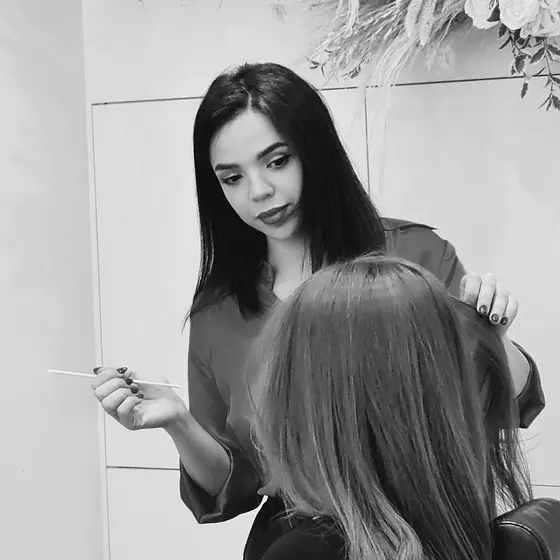 A stylist styling a client’s hair at AFSOO Beauty